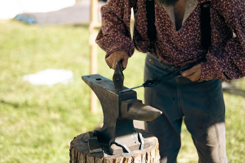 Artisan blacksmith craftsman working at forge creating handmade blades